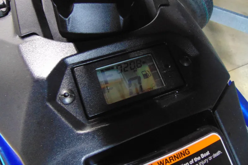 Slide: The Image of 2024 Yamaha WaveRunner JetBlaster dashboard display with digital speedometer and warning label. - 7