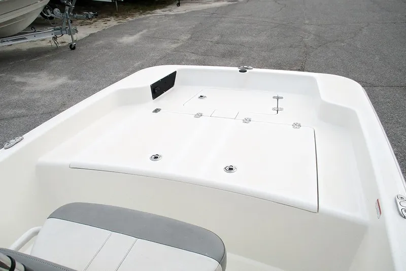 Slide: The Image of 2024 Mako Pro Skiff 15 CC boat deck, featuring storage compartments and seating. - 10