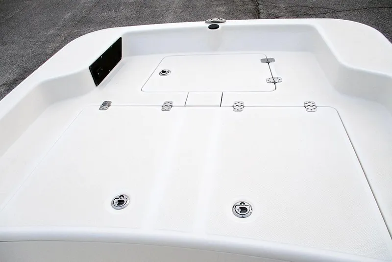 Slide: The Image of 2024 Mako Pro Skiff 15 CC deck with storage compartments and latches. - 11