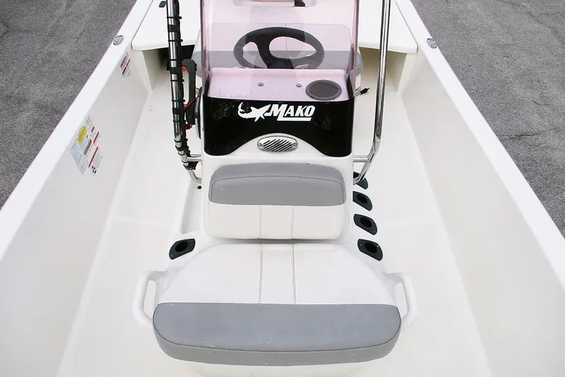 Slide: The Image of 2024 Mako Pro Skiff 15 CC boat interior with steering console and seating. - 14