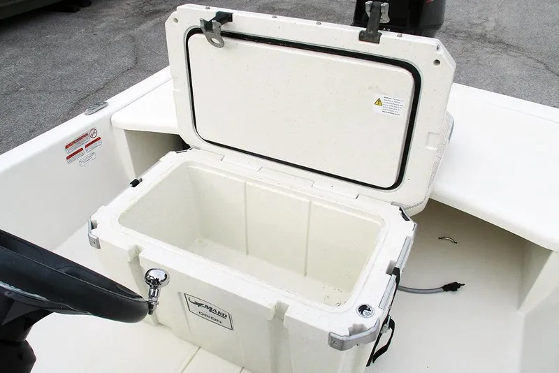 Slide: The Image of 2024 Mako Pro Skiff 15 CC boat with open storage compartment. - 17