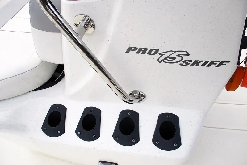 Slide: The Image of 2024 Mako Pro Skiff 15 CC boat interior with rod holders and branding. - 19