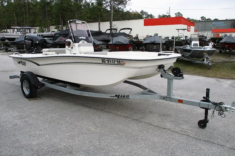 Slide: The Image of 2024 Mako Pro Skiff 15 CC boat on trailer in outdoor dealership. - 3