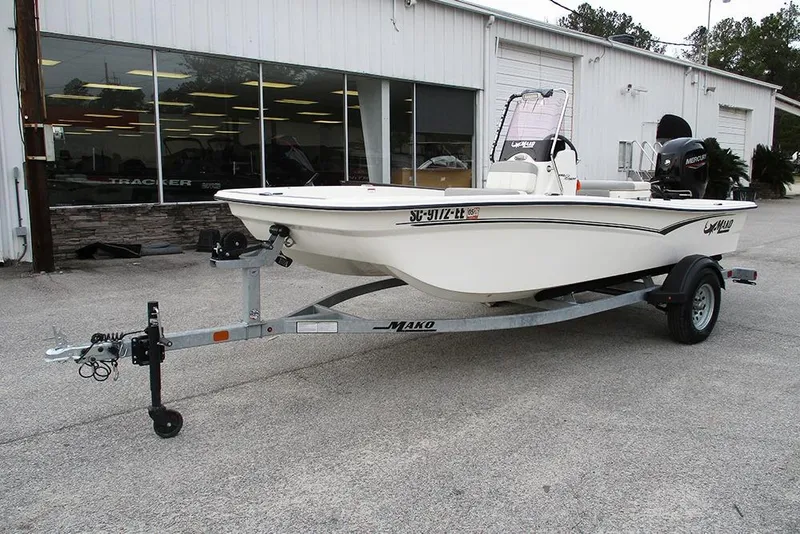 Slide: The Image of 2024 Mako Pro Skiff 15 CC boat on trailer outside dealership. - 5
