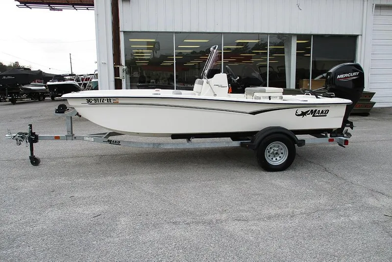 Slide: The Image of 2024 Mako Pro Skiff 15 CC boat on trailer, parked outside dealership. - 6
