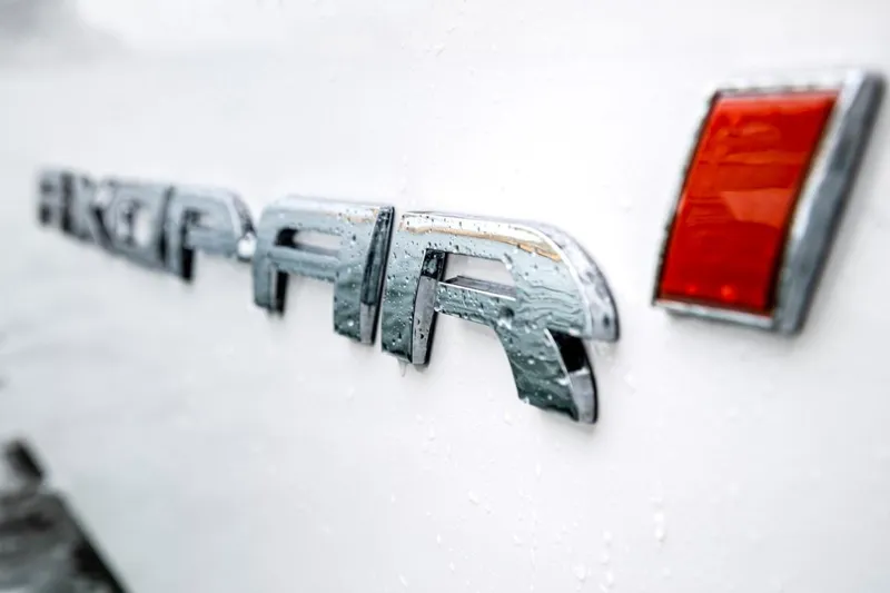 Slide: The Image of 2022 Axopar 28 Cabin boat with teal seating and sleek design. - 17