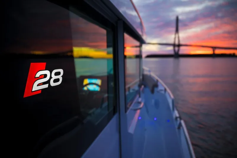 Slide: The Image of 2022 Axopar 28 Cabin boat on trailer with dual Mercury outboard engines. - 2