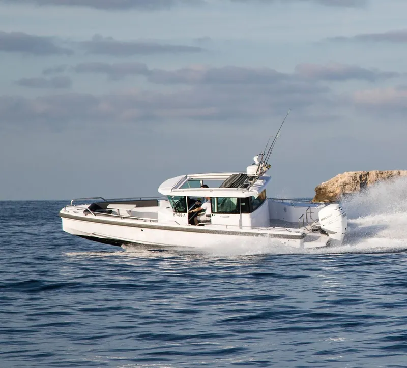 Slide: The Image of 2022 Axopar 28 Cabin boat deck with sleek design and branding. - 21