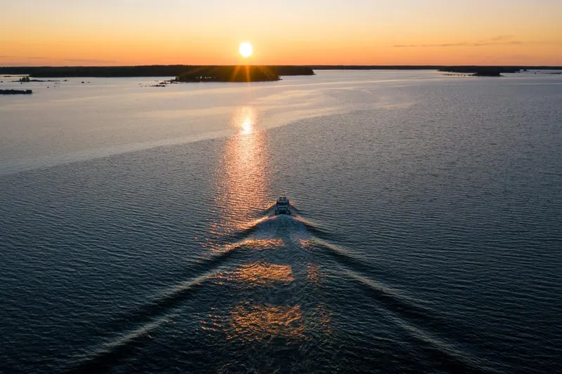 Slide: The Image of 2022 Axopar 28 Cabin boat deck with sleek white finish and logo. - 23