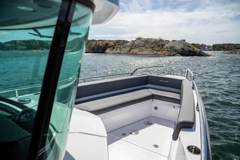 Slide: The Image of 2022 Axopar 28 Cabin with dual Mercury outboard engines at a marina. - 3