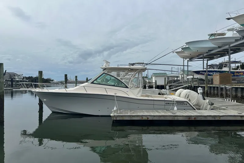 The Image of 2024 Grady-White Express 330 boat docked at marina, side view. - 0