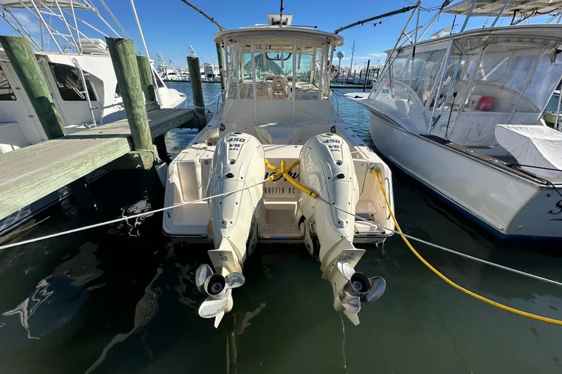 Slide: The Image of 2024 Grady-White Express 330 boat docked with twin outboard engines. - 12