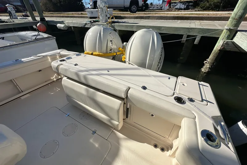 Slide: The Image of 2024 Grady-White Express 330 boat interior with seating and twin outboard motors. - 14