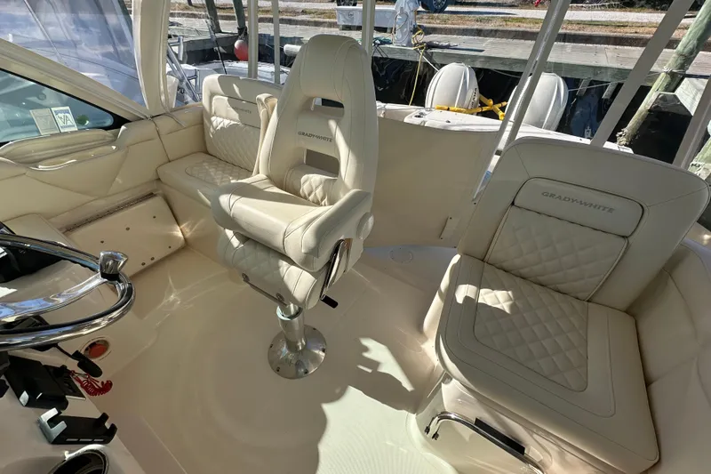 Slide: The Image of 2024 Grady-White Express 330 boat interior with luxurious seating and helm. - 17