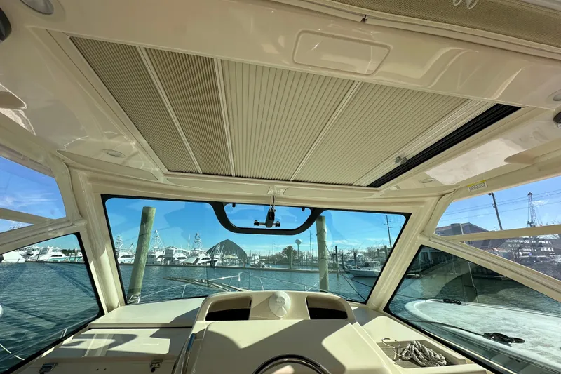 Slide: The Image of Interior view of 2024 Grady-White Express 330 boat with marina backdrop. - 18