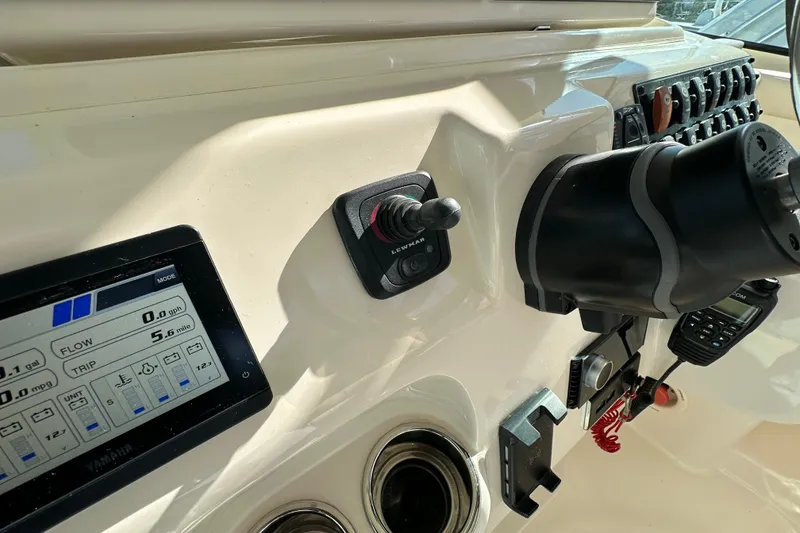 Slide: The Image of 2024 Grady-White Express 330 dashboard with controls and digital display. - 22