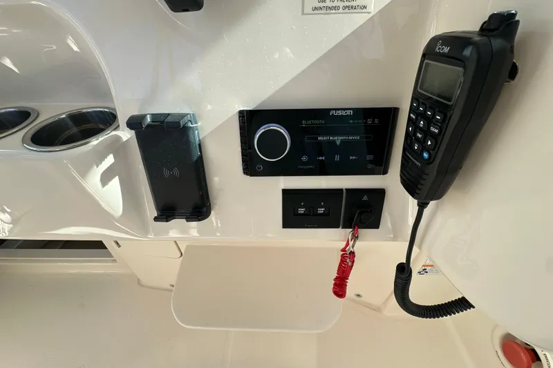 Slide: The Image of 2024 Grady-White Express 330 dashboard with Bluetooth stereo and communication equipment. - 25