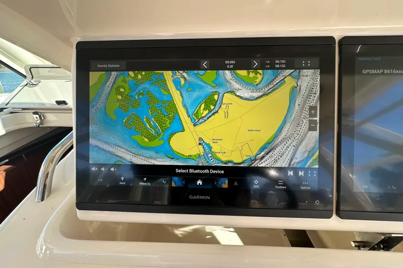 Slide: The Image of Garmin navigation display on 2024 Grady-White Express 330 boat, showing detailed marine map. - 26