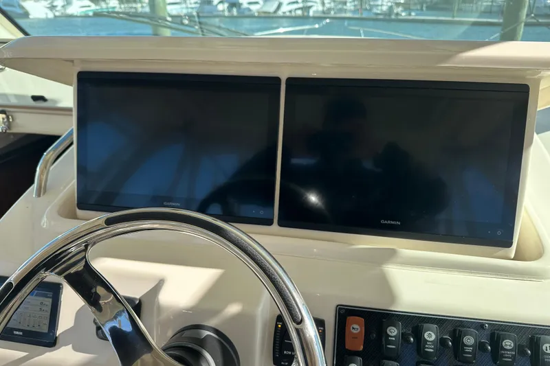 Slide: The Image of 2024 Grady-White Express 330 helm with dual Garmin displays and steering wheel. - 29