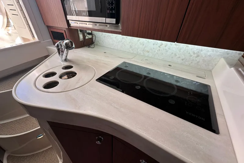 Slide: The Image of 2024 Grady-White Express 330 boat kitchen with modern appliances and sleek countertop design. - 32