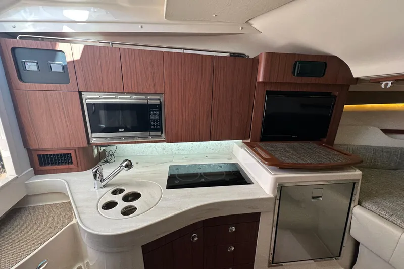 Slide: The Image of 2024 Grady-White Express 330 interior kitchen with modern appliances and sleek design. - 33