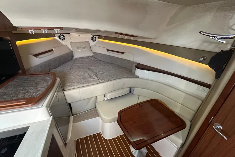 Slide: The Image of 2024 Grady-White Express 330 cabin interior with seating and table. - 36