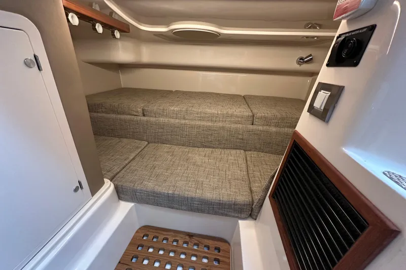 Slide: The Image of 2024 Grady-White Express 330 cabin interior with cushioned seating and modern amenities. - 39