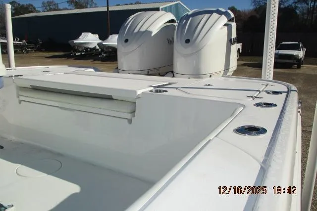 Slide: The Image of 2025 Caymas 281 HB boat with dual engines, docked outdoors. - 3