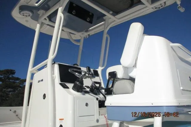Slide: The Image of 2025 Caymas 281 HB boat console and seating under clear blue sky. - 4