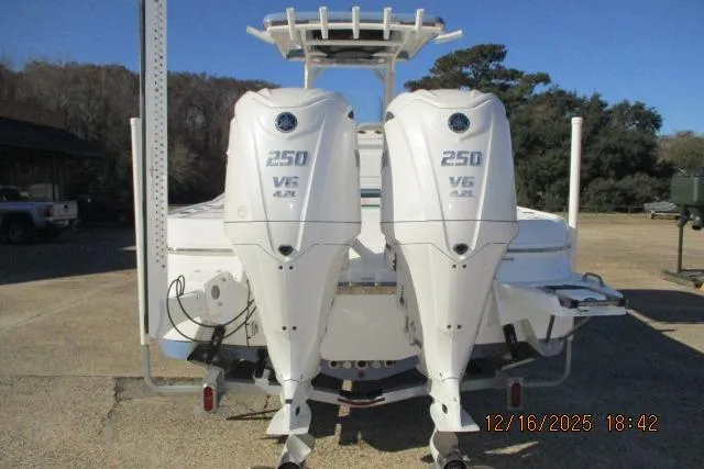 Slide: The Image of 2025 Caymas 281 HB boat with dual 250 V6 outboard engines, rear view. - 6
