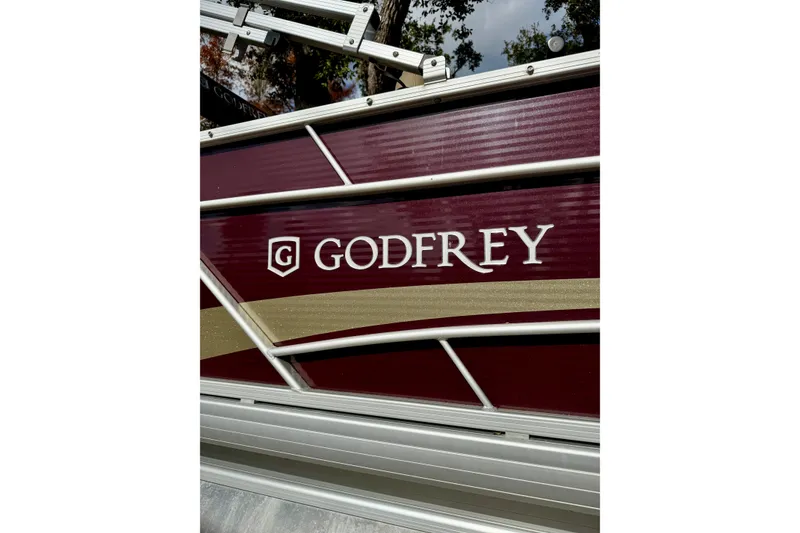 Slide: The Image of 2022 Godfrey Sweetwater 2286 C boat with maroon and gold detailing. - 14