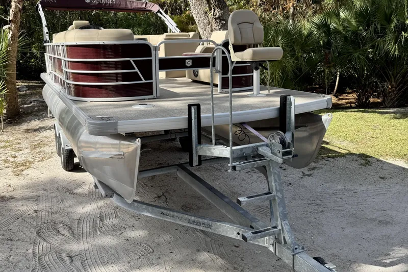 Slide: The Image of 2022 Godfrey Sweetwater 2286 C pontoon boat on trailer, parked outdoors. - 4