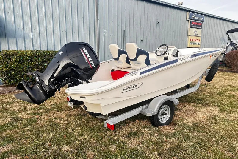 The Image of 2023 Boston Whaler 160 Super Sport boat on trailer, parked outdoors. - 0