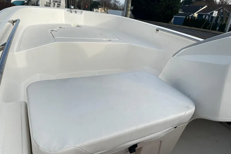 Slide: The Image of 2023 Boston Whaler 160 Super Sport interior seating and storage area. - 11