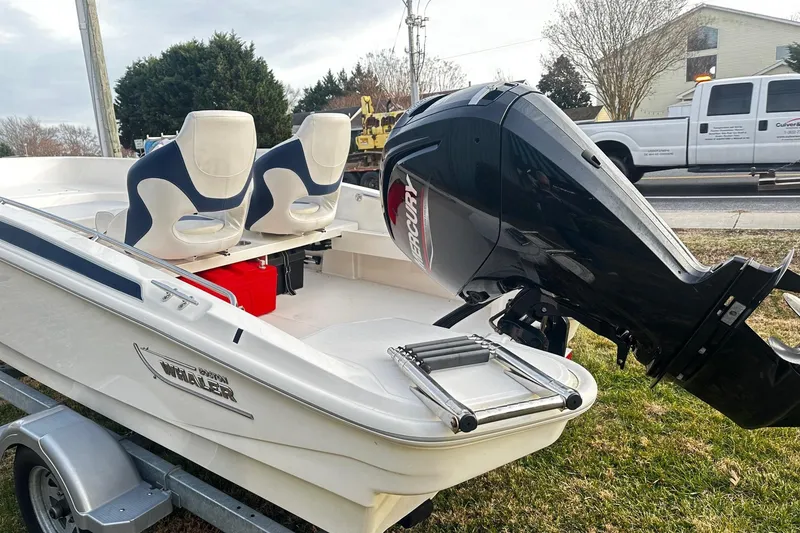 Slide: The Image of 2023 Boston Whaler 160 Super Sport boat with Mercury outboard engine on trailer. - 2