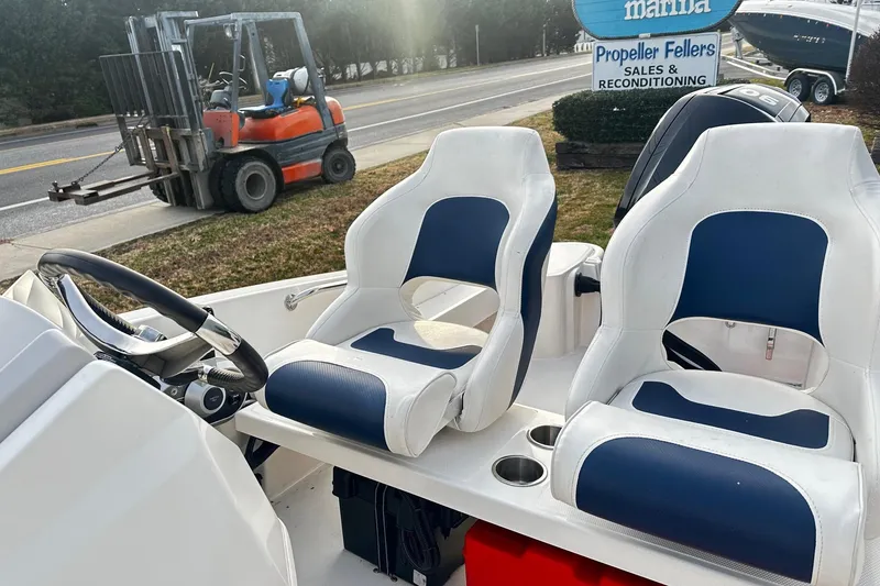 Slide: The Image of 2023 Boston Whaler 160 Super Sport boat interior with blue and white seating. - 4