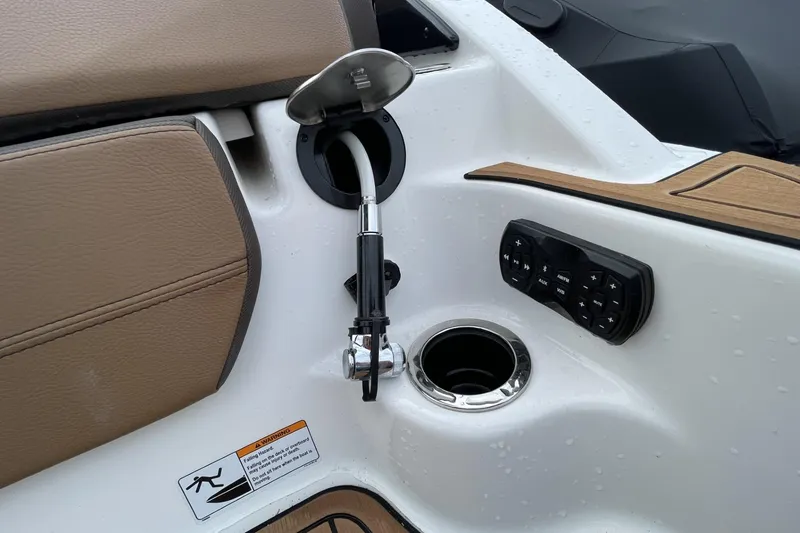 Slide: The Image of 2025 Yamaha Boats 252SD interior detail with cup holder and control panel. - 14