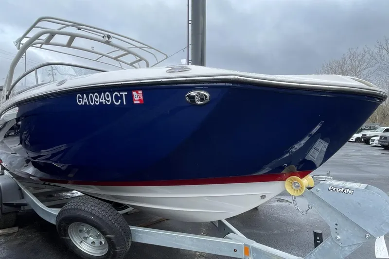 Slide: The Image of 2025 Yamaha Boats 252SD with sleek design and comfortable seating on a trailer. - 2