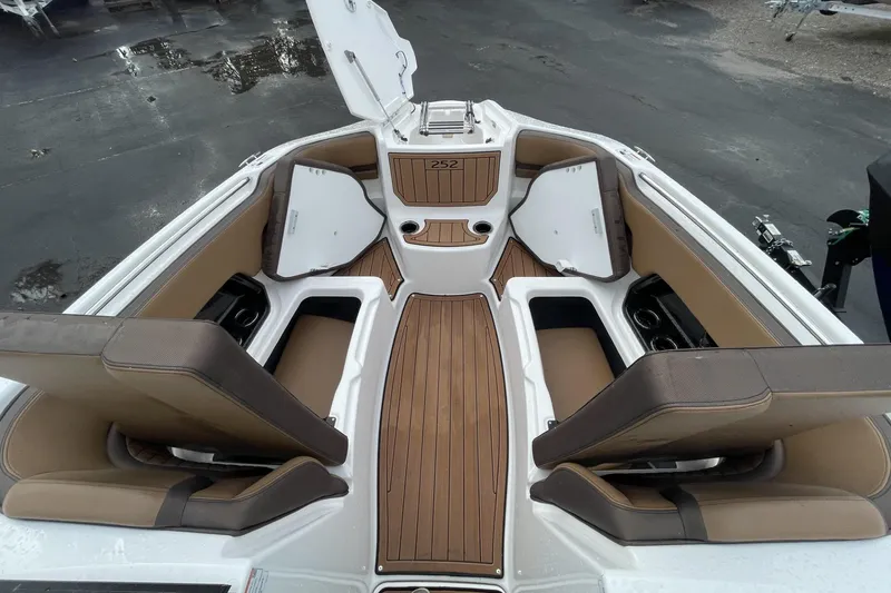 Slide: The Image of 2025 Yamaha Boats 252SD interior with brown seating and wood-style flooring. - 4