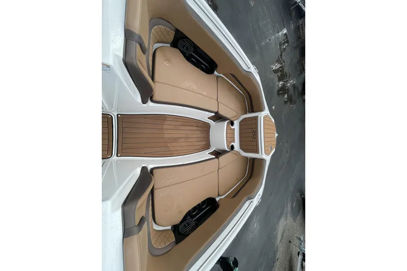 Slide: The Image of 2025 Yamaha Boats 252SD interior with tan seating and wood accents. - 5