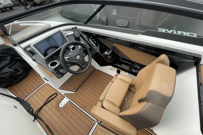 Slide: The Image of 2025 Yamaha Boats 252SD cockpit with modern dashboard, steering wheel, and tan seating. - 7