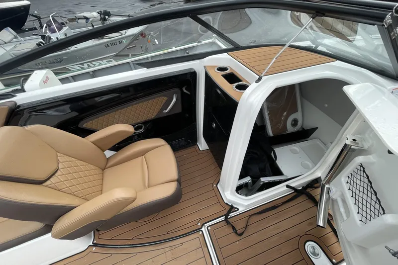 Slide: The Image of 2025 Yamaha Boats 252SD interior with tan seating and wood accents. - 8