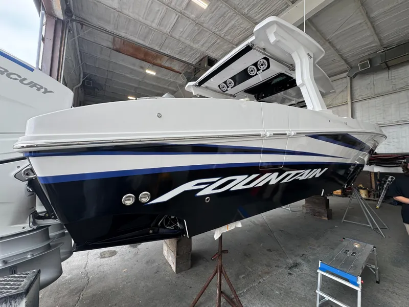 Slide: The Image of 2025 Fountain 38 SCX boat in a garage, showcasing sleek design and branding. - 12