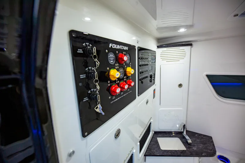 Slide: The Image of Control panel inside 2025 Fountain 38 SCX boat cabin, featuring switches and keys. - 29
