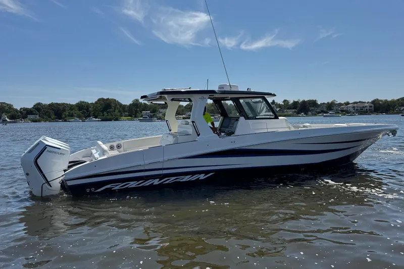 Slide: The Image of 2025 Fountain 38 SCX boat on calm water, featuring sleek design and powerful Mercury engine. - 5