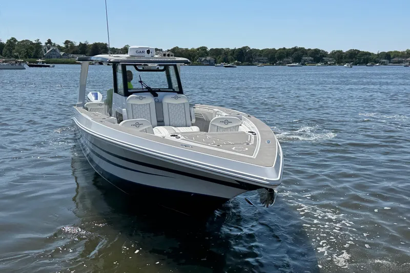 Slide: The Image of 2025 Fountain 38 SCX boat on calm water, showcasing sleek design and modern features. - 6