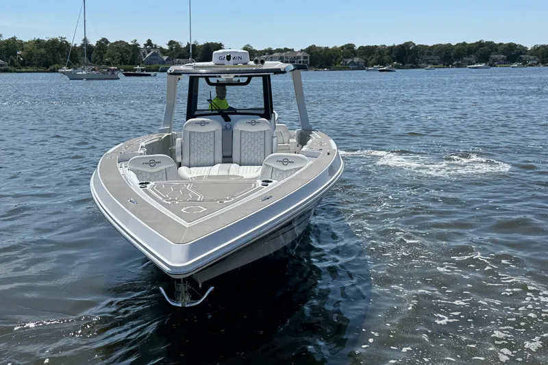 Slide: The Image of 2025 Fountain 38 SCX boat on calm water, showcasing sleek design and modern features. - 7