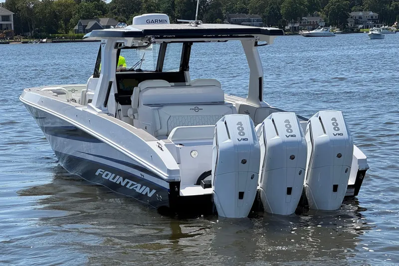 Slide: The Image of 2025 Fountain 38 SCX boat with triple 400 V10 engines on a calm lake. - 8
