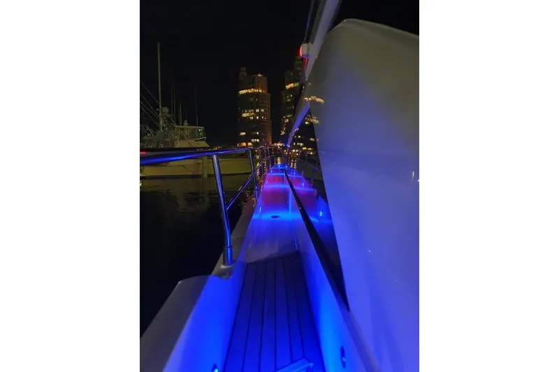 Slide: The Image of Night view of 2010 Fairline Squadron 55 yacht with blue deck lights. - 10