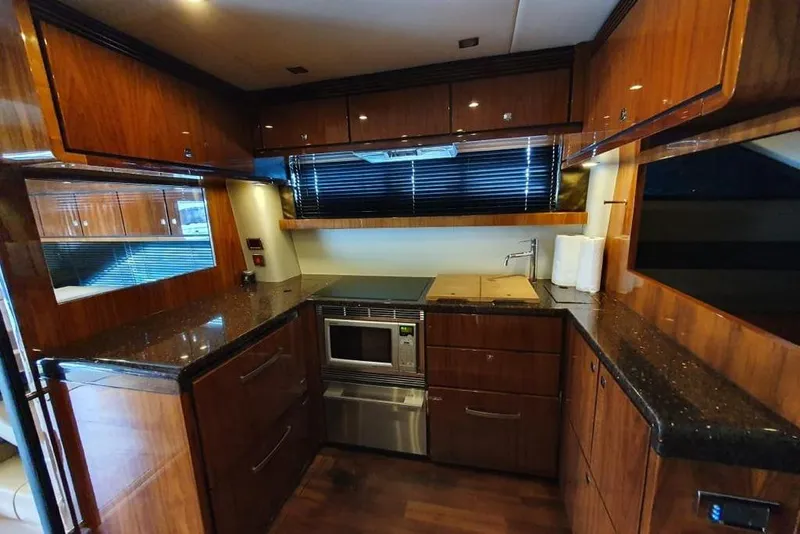 Slide: The Image of Luxurious kitchen interior of 2010 Fairline Squadron 55 yacht with wood cabinetry and modern appliances. - 13